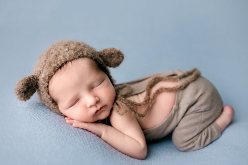 baby boy in blue on newborn session