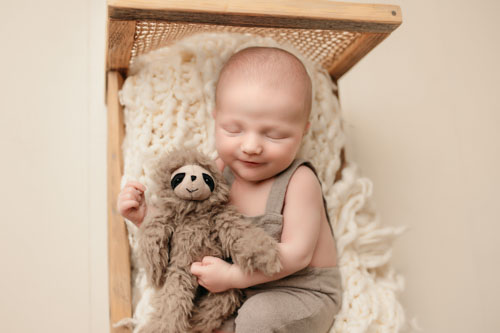 newborn baby with teddy photographed in preston photography studio