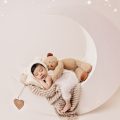 baby posed on a beautiful moon prop with teddy, during newborn photoshoot in Preston studio