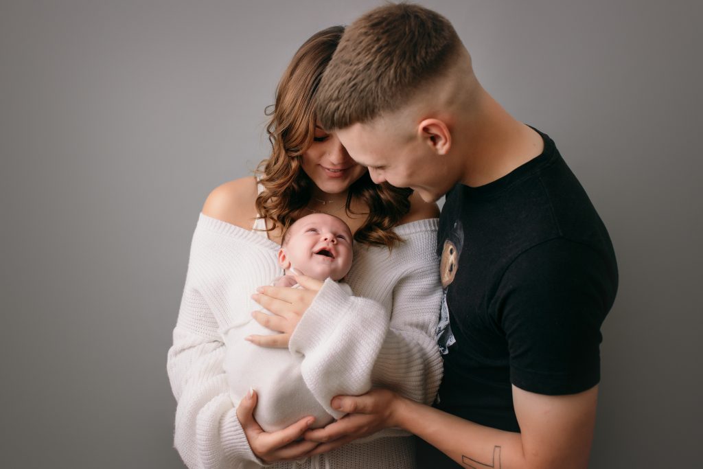 newborn photoshoot in preston, baby held by parents, family photos