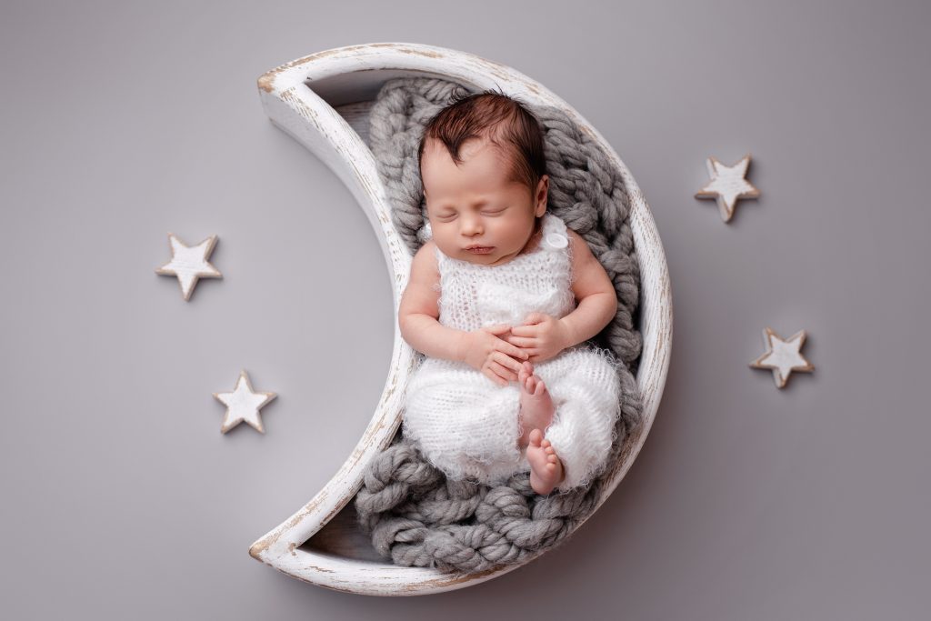 baby boy in the moon prop on the newborn session in Preston, Lancashire